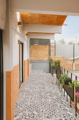 a balcony with a tile floor in a house at Casa Layu Oaxaca in Oaxaca City
