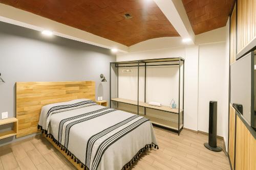 a bedroom with a bed and a walk in shower at Casa Layu Oaxaca in Oaxaca City