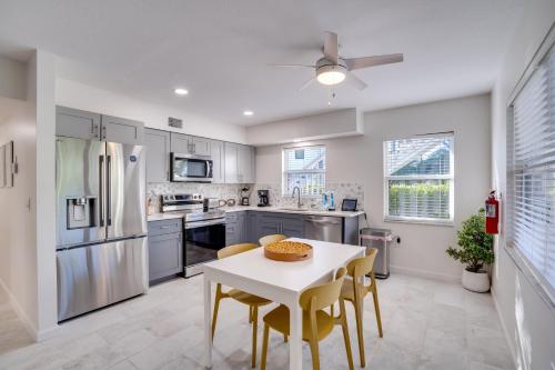 a kitchen with a white table and yellow chairs at Approx 40 steps to beach entrance of Anna Maria beach in Anna Maria