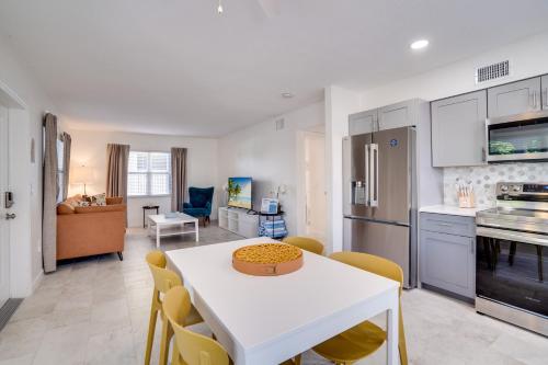 a kitchen and living room with a white table and chairs at Approx 40 steps to beach entrance of Anna Maria beach in Anna Maria