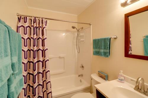 a bathroom with a shower and a toilet and a sink at Pet-Friendly Cabin with Designated Boat Slip! in Fairfield Bay