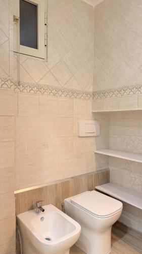 a bathroom with a white toilet and a sink at Ginevra house in Naples