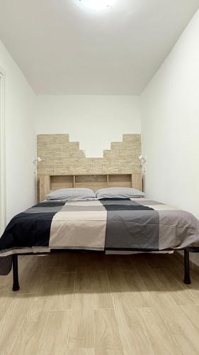 a bedroom with a large bed in a white room at Ginevra house in Naples