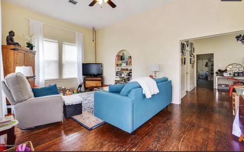 a living room with a blue couch and two chairs at Modern Cajun Retreat Near Downtown in Lafayette