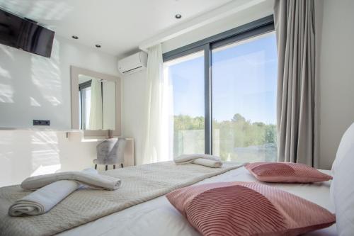 Postel nebo postele na pokoji v ubytování Villa Maria Laganas