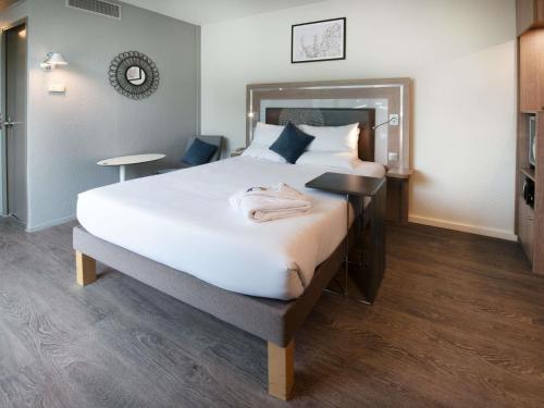 Кровать или кровати в номере Novotel Senart Golf De Greenparc