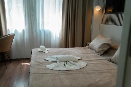 a hotel room with two towels on a bed at Imperium Taxim in Istanbul