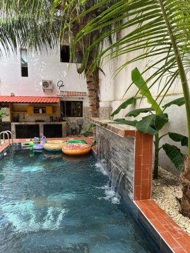 a swimming pool with a water slide in a backyard at Suite privée-chambre, salon et cuisine complete in Mbour