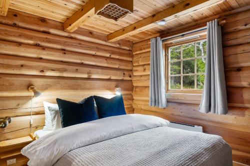 a bedroom with a bed in a wooden room at Trysilfjell 440 by Vacation Trysil in Hovi