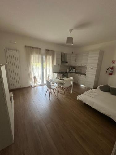a living room with a bed and a table and chairs at B&B Alèsia in Montesilvano