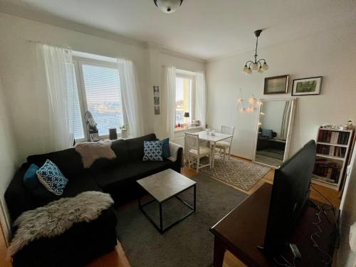 a living room with a couch and a table at Charming one-bedroom apartment in Grand House in the city center of Kokkola in Kokkola