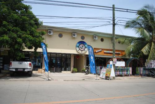 a store with blue signs in front of a street at Captain's Lodge and Bar in Panglao