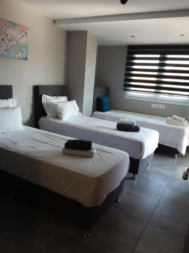 two beds in a room with a window at Villa Joanna 4 in Mesimérion