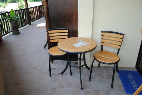 a wooden table and chairs sitting on a balcony at Captain's Lodge and Bar in Panglao