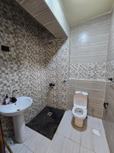 a bathroom with a toilet and a sink at Ghazala Bay Hotel in Dahab