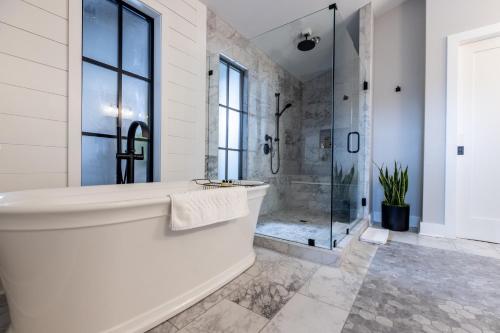 a white bathroom with a tub and a shower at Nicewonder Farm & Vineyards in Bristol
