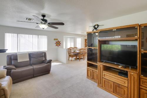 a living room with a flat screen tv and a couch at Quaint Bullhead City Getaway about 2 Mi to River! in Bullhead City
