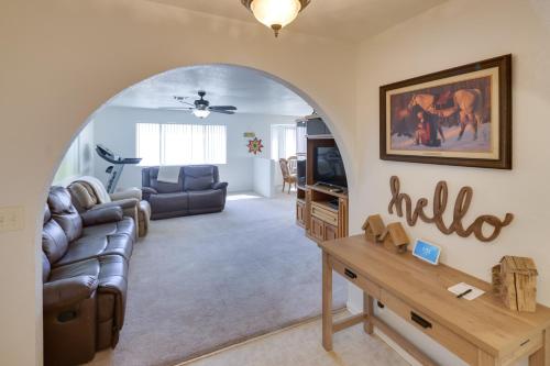 a living room with a couch and a tv at Quaint Bullhead City Getaway about 2 Mi to River! in Bullhead City