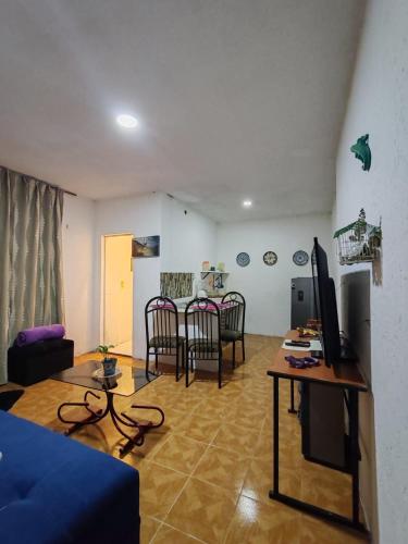 a living room with a blue couch and a table at Abuelita in Santa María Tonantzintla