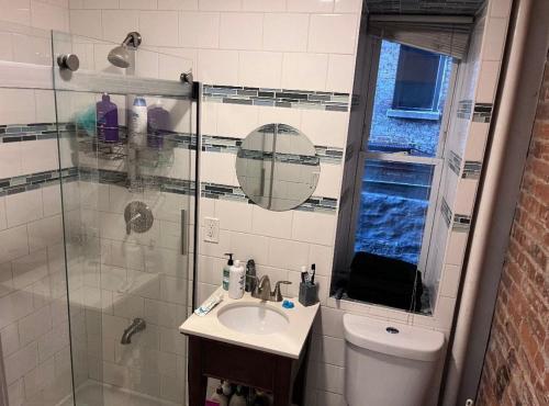 a bathroom with a toilet and a sink and a shower at Central Park Northwest Corner - Harlem in New York