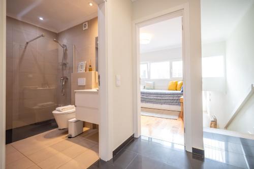a bathroom with a shower and a toilet and a sink at Casa Alecrim in Tavira