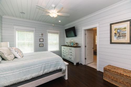 a bedroom with a bed and a ceiling fan at A Pura Vida in Edisto Island