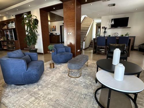 a lobby with blue chairs and tables in a building at Best Western Cumbres Inn Cd. Cuauhtemoc in Cuauhtémoc