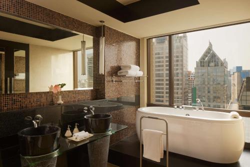a bathroom with a sink and a large window at Banyan Tree Bangkok in Bangkok