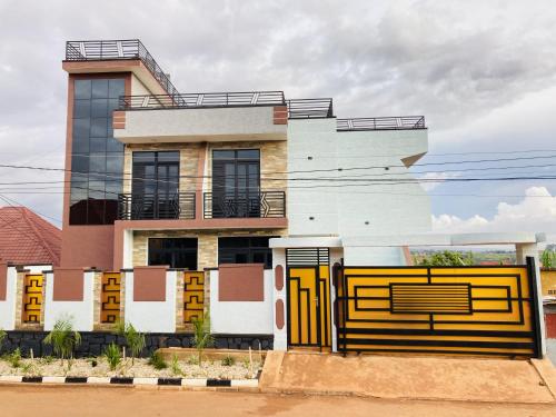 a building with a yellow gate in front of it at Lakes view apartments in Kigali