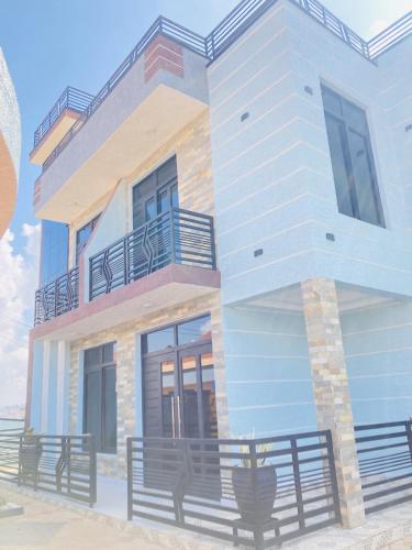 a rendering of a house with benches in front of it at Lakes view apartments in Kigali