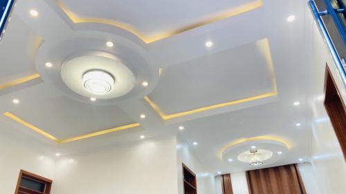 a coffered ceiling with gold trim and a ceiling fan at Lakes view apartments in Kigali