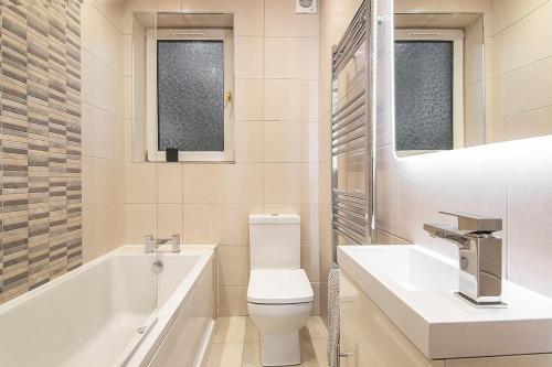 Private Hot Tub - Zen & Bubbles في إدنبرة: حمام مع حوض استحمام ومرحاض ومغسلة