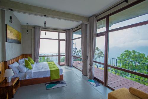 a bedroom with a bed and a balcony at The Ledge Ella in Ella