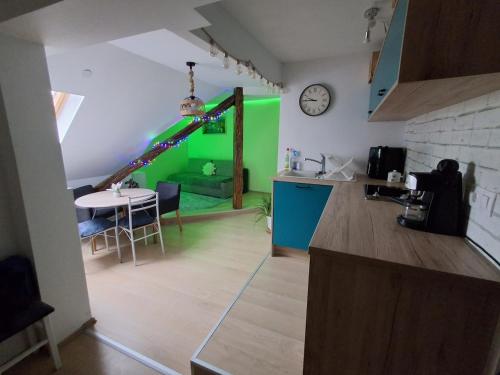 a kitchen with a water slide in a room at KissApartman in Kőszeg