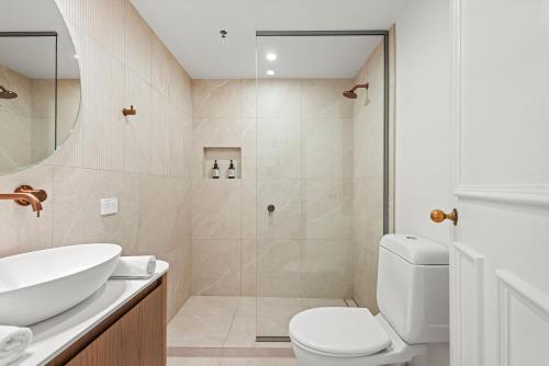 a bathroom with a shower and a toilet and a sink at Character Central in Christchurch