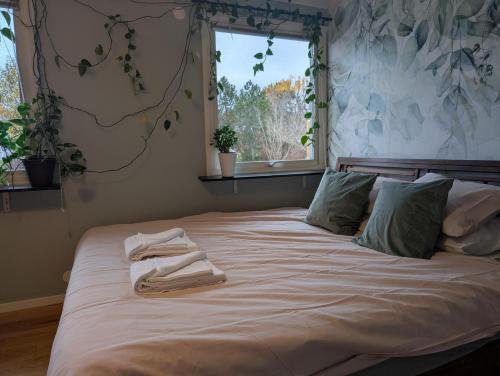 a bedroom with a bed with towels on it at Home in Vingåker in Vingåker