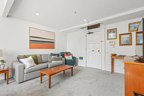 a living room with a couch and a table at Character Central in Christchurch