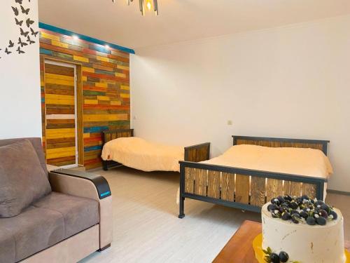 a living room with a bed and a couch at Church-View Lodge by Green Garden, Dilijan in Dilijan