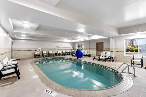 a large pool in a hotel room with chairs at Country Inn & Suites By Radisson, Charleston North, SC in Charleston