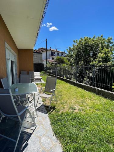a patio with chairs and a table and a fence at Lily House in Luino