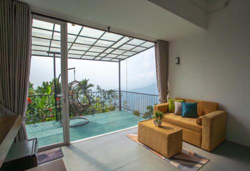 a living room with a couch and a large window at The Ledge Ella in Ella