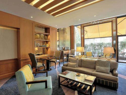 a living room with a couch and a table at Sofitel Beirut Le Gabriel in Beirut