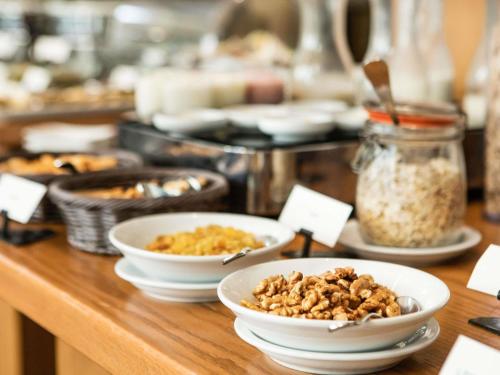 a buffet with bowls of food on a table at Sofitel Beirut Le Gabriel in Beirut