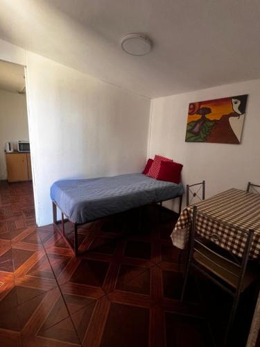 a room with a bed in the corner of a room at Cabañas Costatour Quintero in Quintero