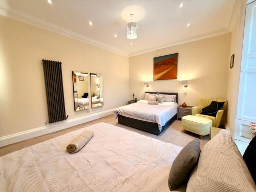 a hotel room with two beds and a couch at Georgian Luxury Apartment - Fast Broadband WiFi - Parking Available in Edinburgh