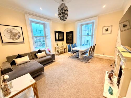 a living room with a couch and a table at Georgian Luxury Apartment - Fast Broadband WiFi - Parking Available in Edinburgh