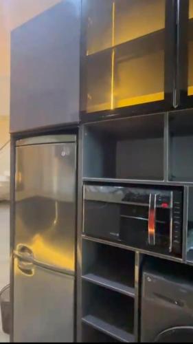 una cocina con nevera y microondas en Emerald harbour apartments, en Epe