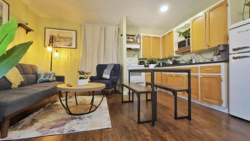 a kitchen and living room with a couch and a table at 1-Bedroom Retreat Apt 3 in Bridgewater