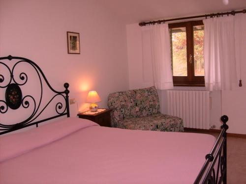 Un pat sau paturi într-o cameră la L'Oasi