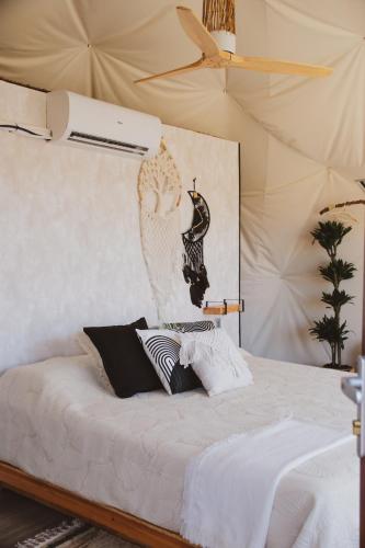 a white bed with two pillows on top of it at Seed Domo Tarifa in Betis